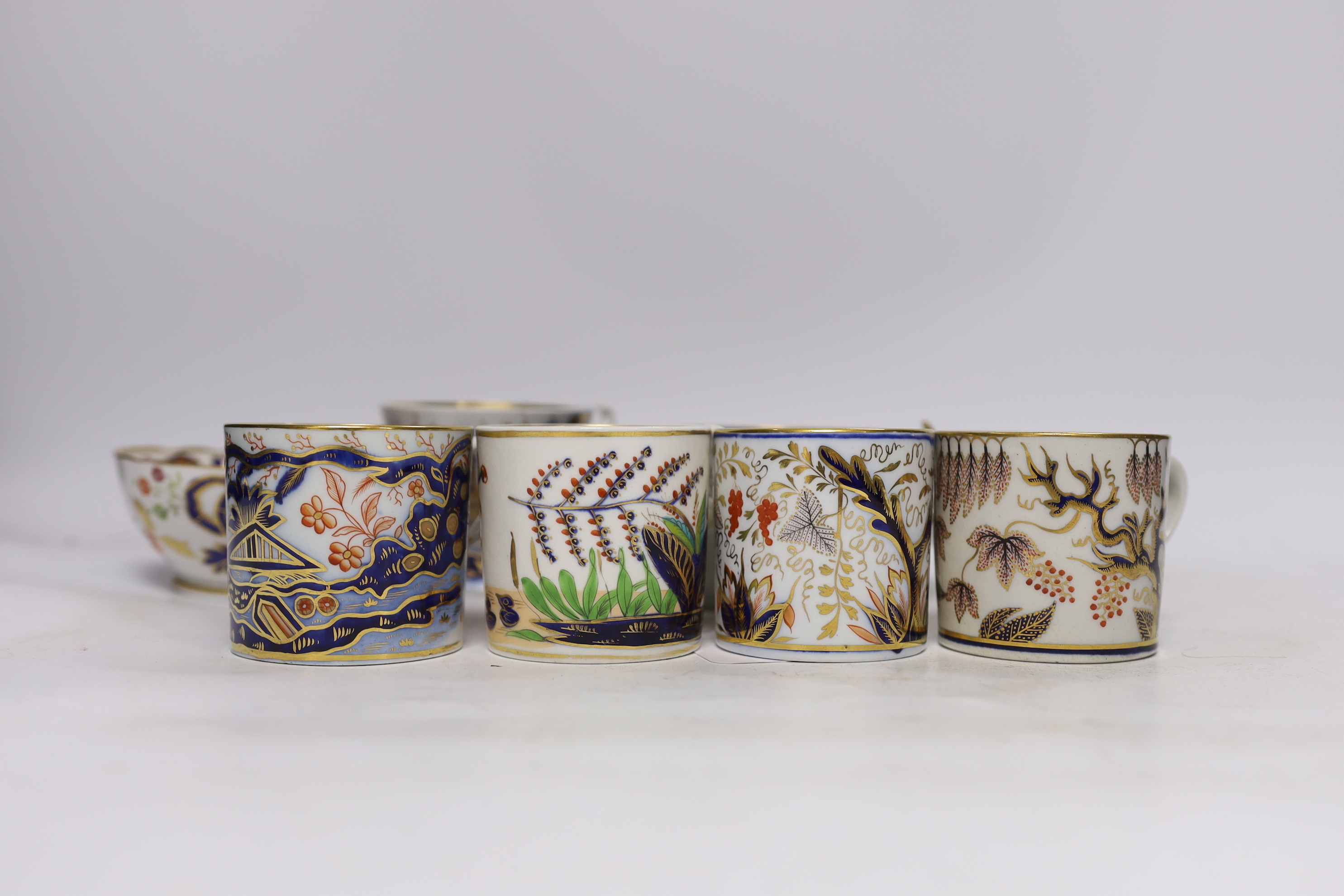 Eleven 1800-1820 English porcelain coffee cans and tea cups, including Imari pattern examples, one with matching saucer